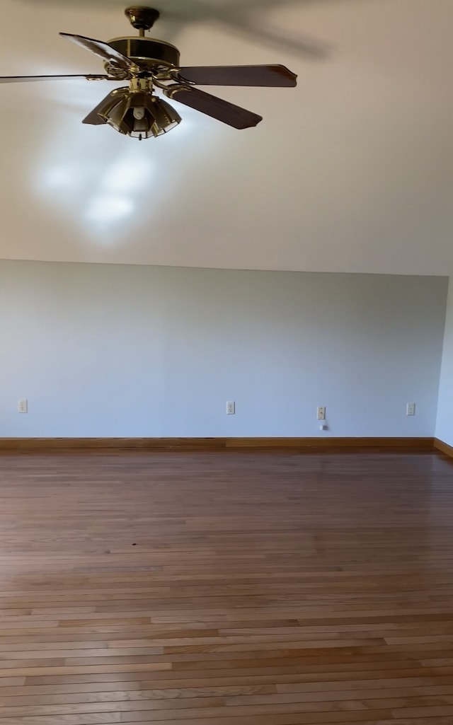 additional living space featuring ceiling fan and hardwood / wood-style flooring