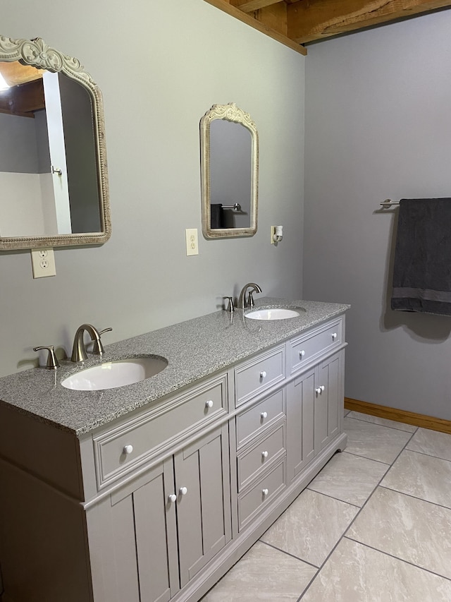 bathroom with tile patterned flooring and dual bowl vanity