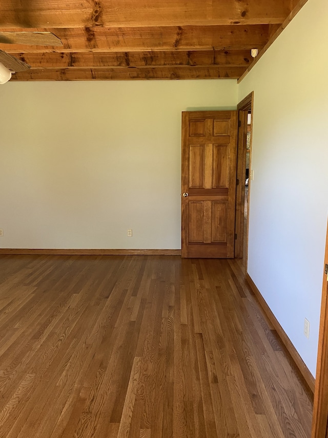 spare room with wood ceiling, hardwood / wood-style flooring, and beamed ceiling