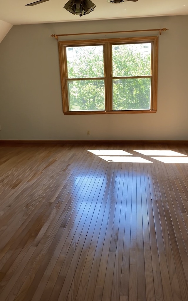 interior space with hardwood / wood-style floors, vaulted ceiling, and ceiling fan