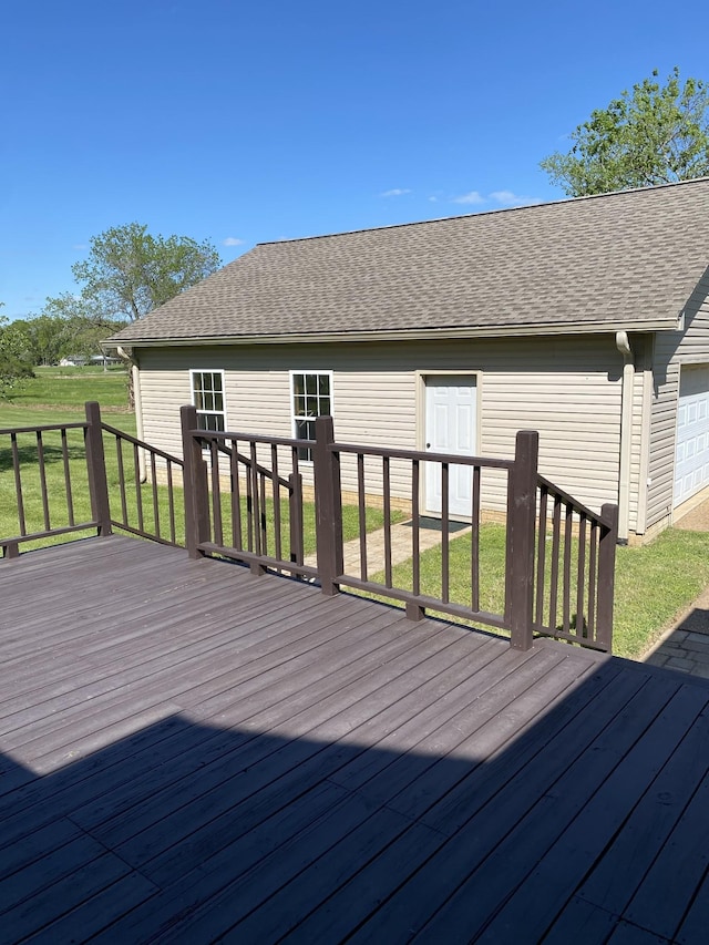 wooden deck featuring a yard