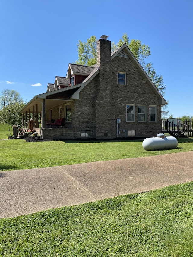 view of side of home featuring a yard and a chimney