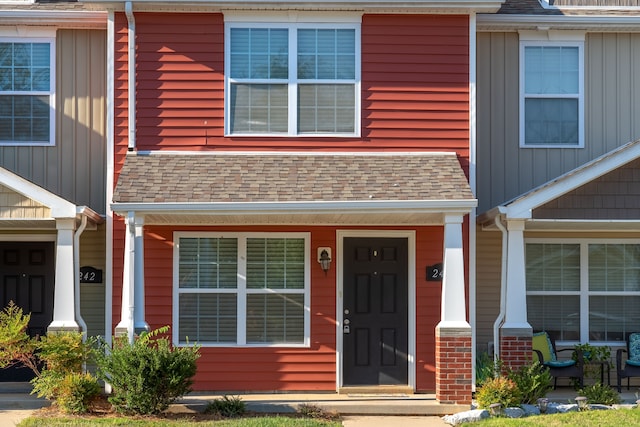 townhome / multi-family property featuring covered porch