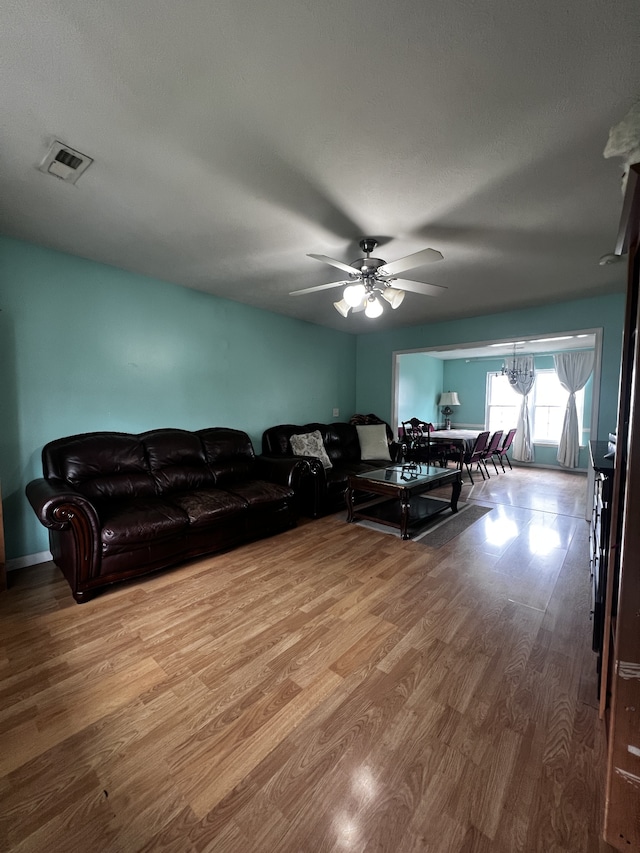 living room featuring ceiling fan and hardwood / wood-style floors