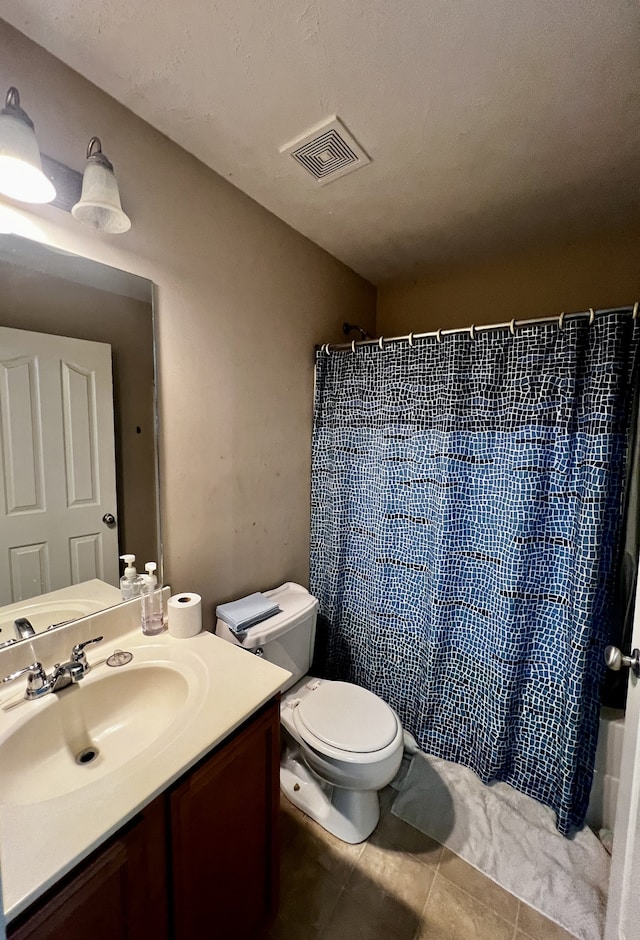 bathroom with tile patterned flooring, toilet, and vanity