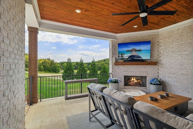 view of patio / terrace with ceiling fan and an outdoor brick fireplace