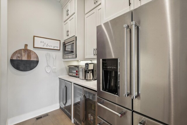 kitchen featuring white cabinetry, dark wood-type flooring, and stainless steel appliances