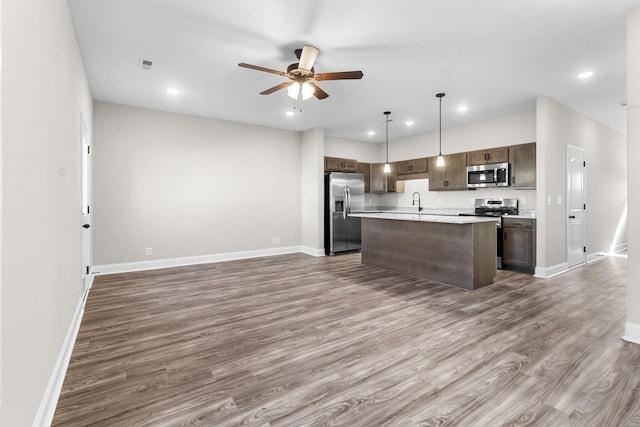 203 W Fallow Ct, Clarksville, TN 37040 - kitchen featuring stainless steel appliances, open floor plan, wood finished floors, ceiling fan, and a center island