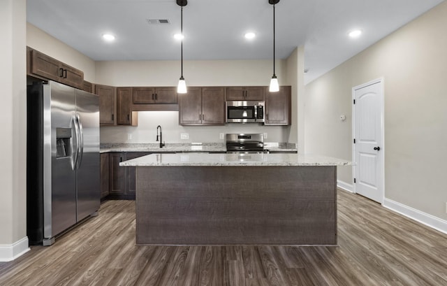 203 W Fallow Ct, Clarksville, TN 37040 - kitchen with stainless steel appliances, dark brown cabinets, dark wood-style flooring, a kitchen island, and recessed lighting