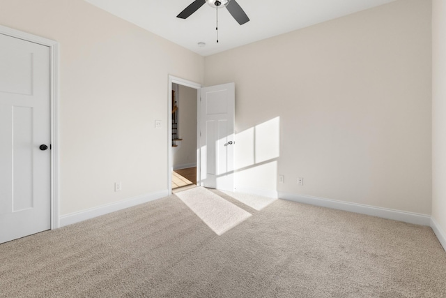 empty room featuring light colored carpet and ceiling fan