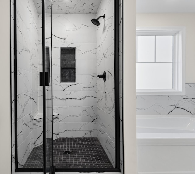 bathroom featuring plus walk in shower and a wealth of natural light