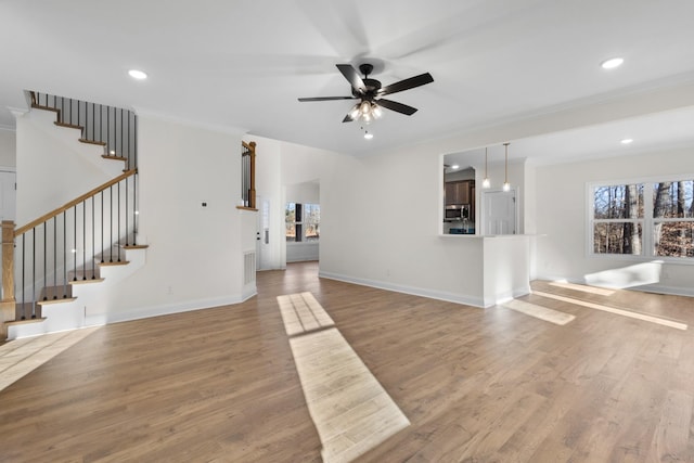 unfurnished living room featuring crown molding, ceiling fan, and hardwood / wood-style flooring