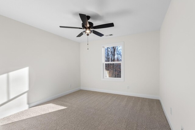 spare room with ceiling fan and carpet floors