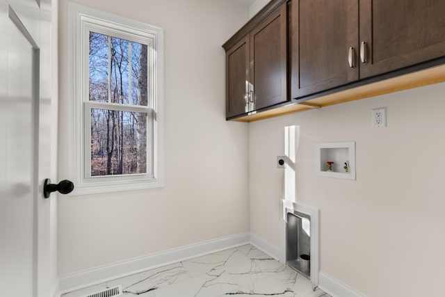 laundry room featuring washer hookup, electric dryer hookup, and cabinets