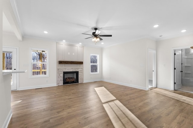 unfurnished living room with ceiling fan, wood-type flooring, and ornamental molding