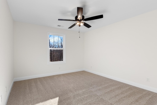 carpeted spare room with ceiling fan