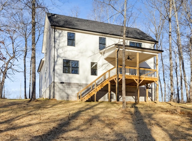 rear view of property featuring a wooden deck and ceiling fan