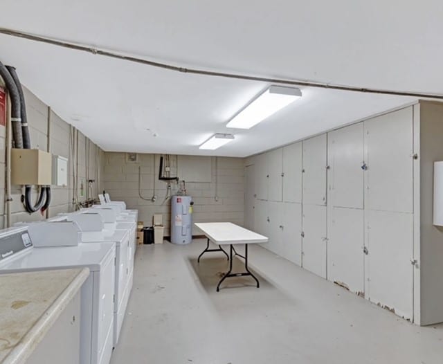 basement with water heater and washer and dryer