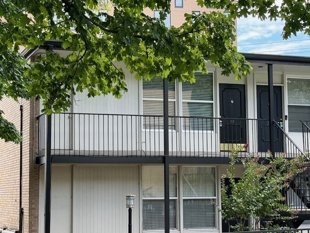 view of side of home with a balcony