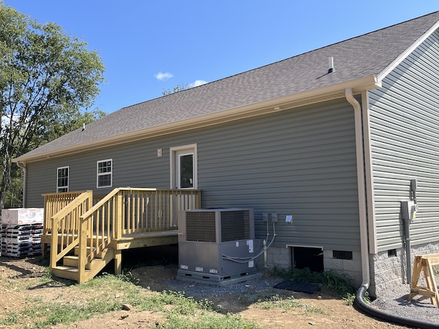 back of house featuring a wooden deck and central AC