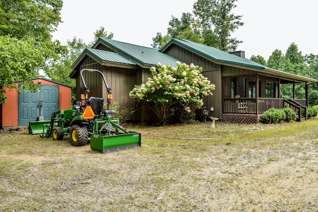 rear view of house with a yard and a shed