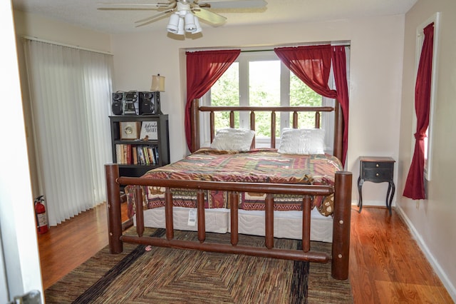 bedroom with hardwood / wood-style flooring and ceiling fan