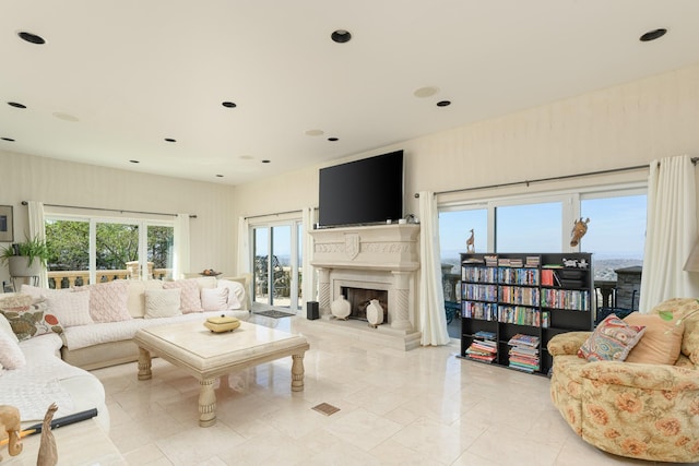 living area with a fireplace with raised hearth