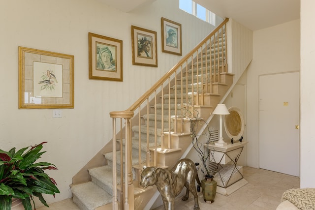 stairway featuring tile patterned flooring