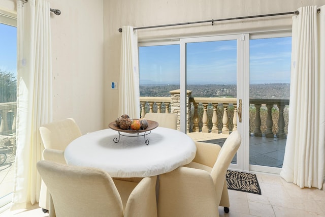 dining room featuring light tile patterned flooring and plenty of natural light