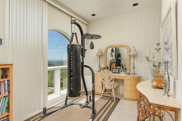 exercise area featuring light tile patterned flooring