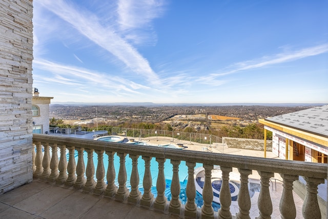 balcony with a fenced in pool and a patio