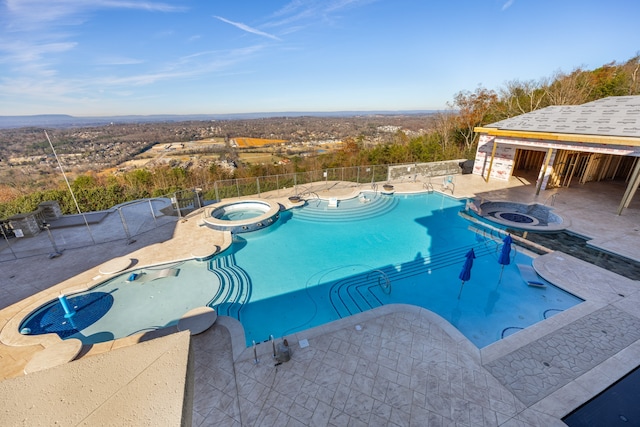 view of swimming pool with an in ground hot tub and a patio