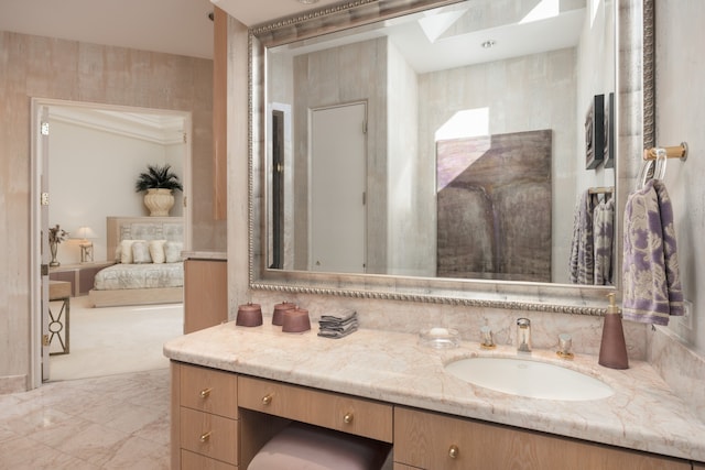 bathroom featuring tile patterned flooring, vanity, and tile walls