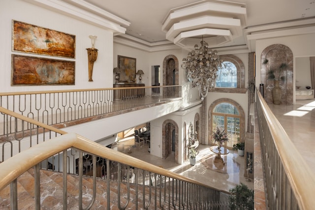 interior space featuring ornamental molding and a notable chandelier