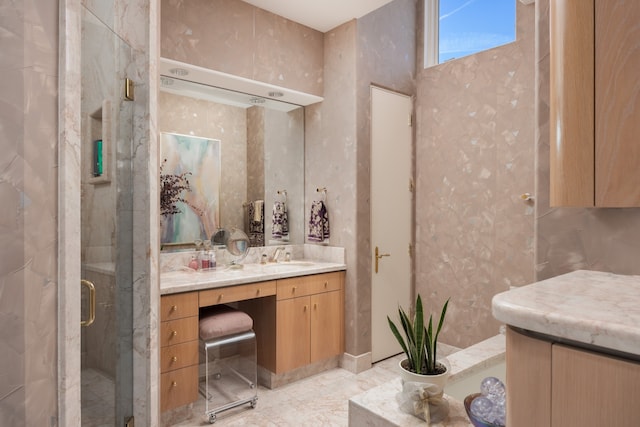 bathroom with tile patterned flooring, walk in shower, and vanity