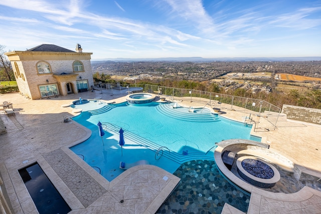 view of pool with an in ground hot tub and a patio