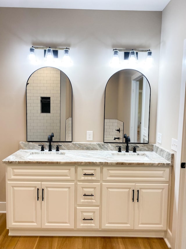 bathroom featuring double vanity, a sink, and decorative backsplash