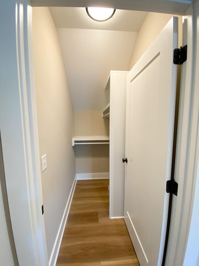 walk in closet featuring lofted ceiling and light wood-style flooring