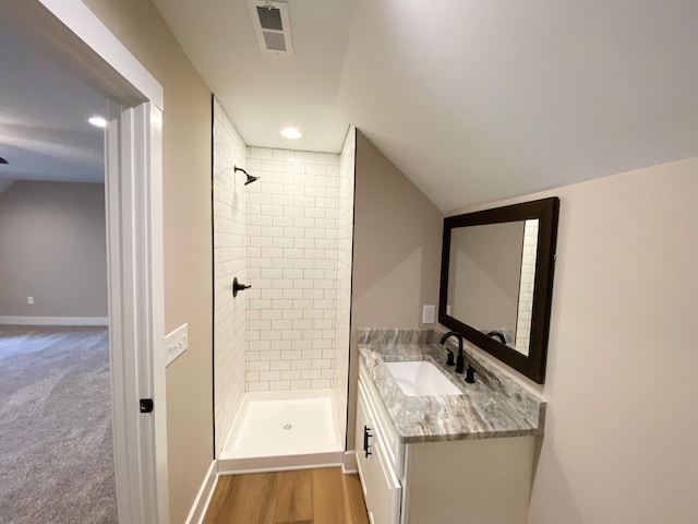 bathroom featuring a stall shower, vanity, visible vents, and baseboards