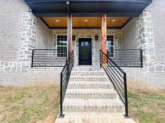 doorway to property with brick siding