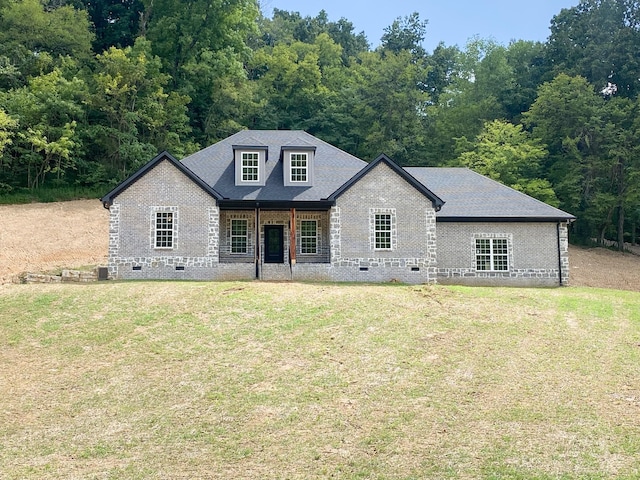 view of front of home with brick siding, crawl space, a front yard, and a shingled roof