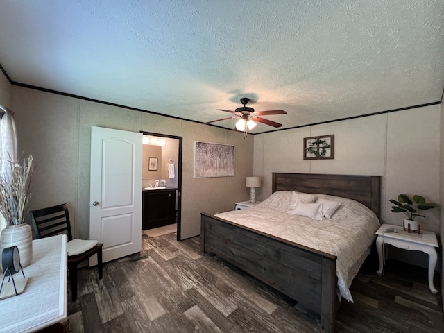 bedroom with dark wood-type flooring, connected bathroom, a textured ceiling, and ceiling fan