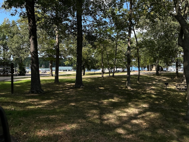 view of community with a lawn and a water view