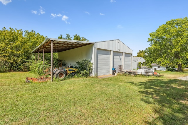 exterior space with a carport, an outdoor structure, and a garage