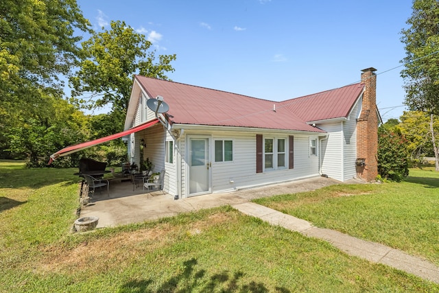 back of house featuring a patio and a lawn