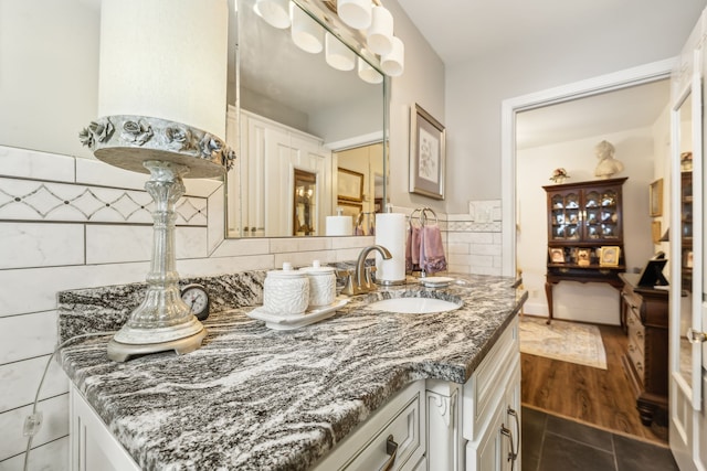 bathroom featuring hardwood / wood-style flooring, decorative backsplash, vanity, and tile walls