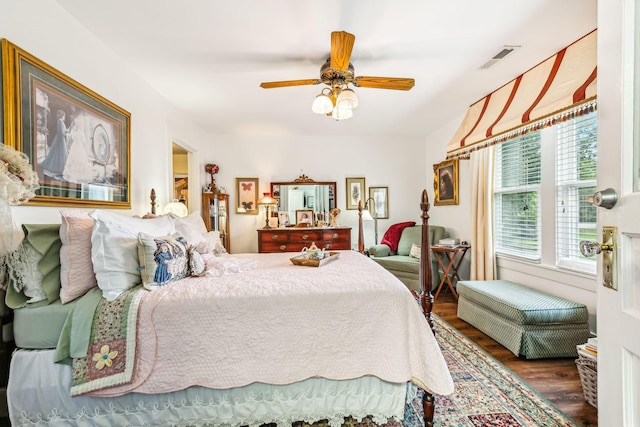 bedroom featuring ceiling fan, dark wood finished floors, and visible vents