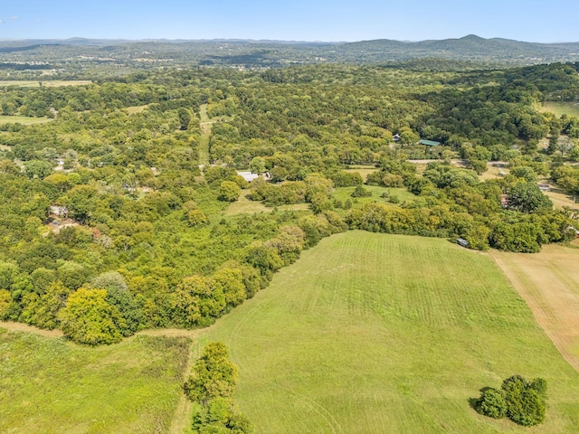 birds eye view of property with a mountain view and a wooded view