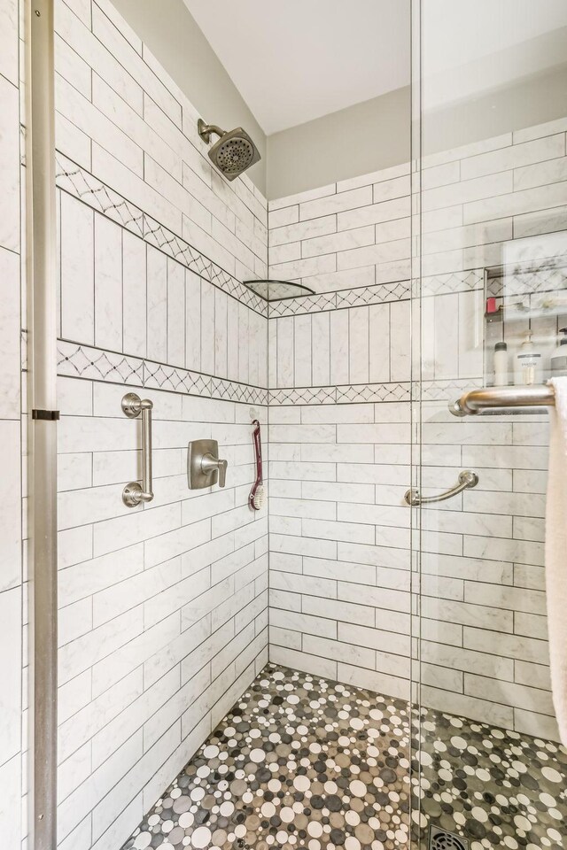 bathroom featuring a shower with door