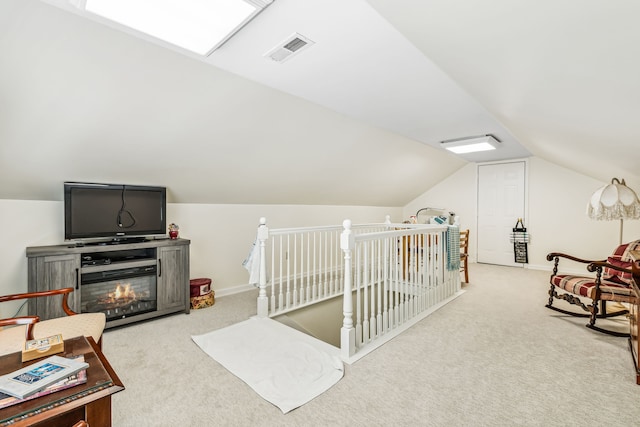 carpeted bedroom with lofted ceiling